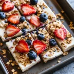 High Protein Greek Yogurt Bark: The Best Frozen Snack You’ll Love High Protein Greek Yogurt Bark Sliced high protein Greek yogurt bark topped with strawberries, blueberries, and granola
