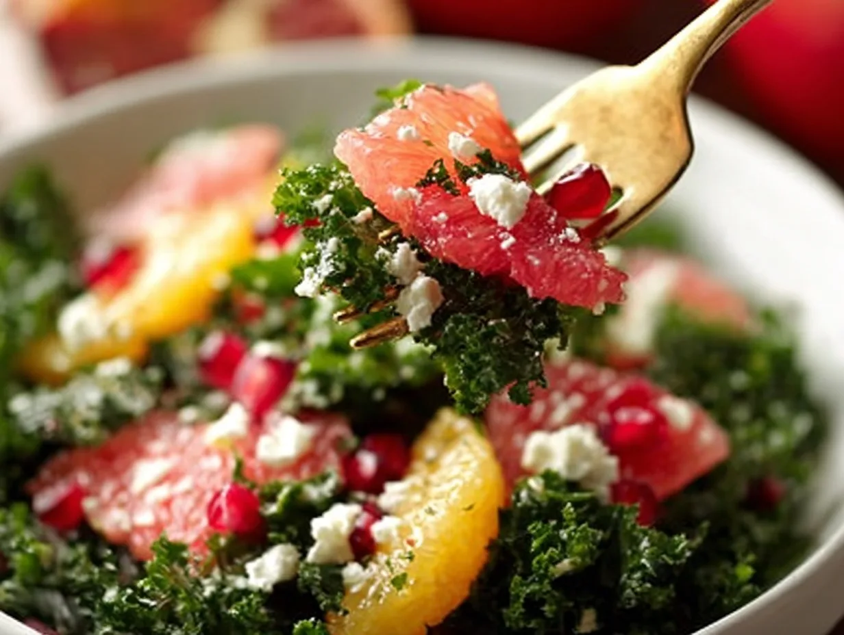 fork lifting winter citrus and kale salad with grapefruit, feta, and pomegranate