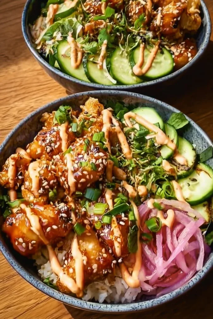 Delicious Bang Bang Chicken Bowls with vibrant vegetables and spicy sauce