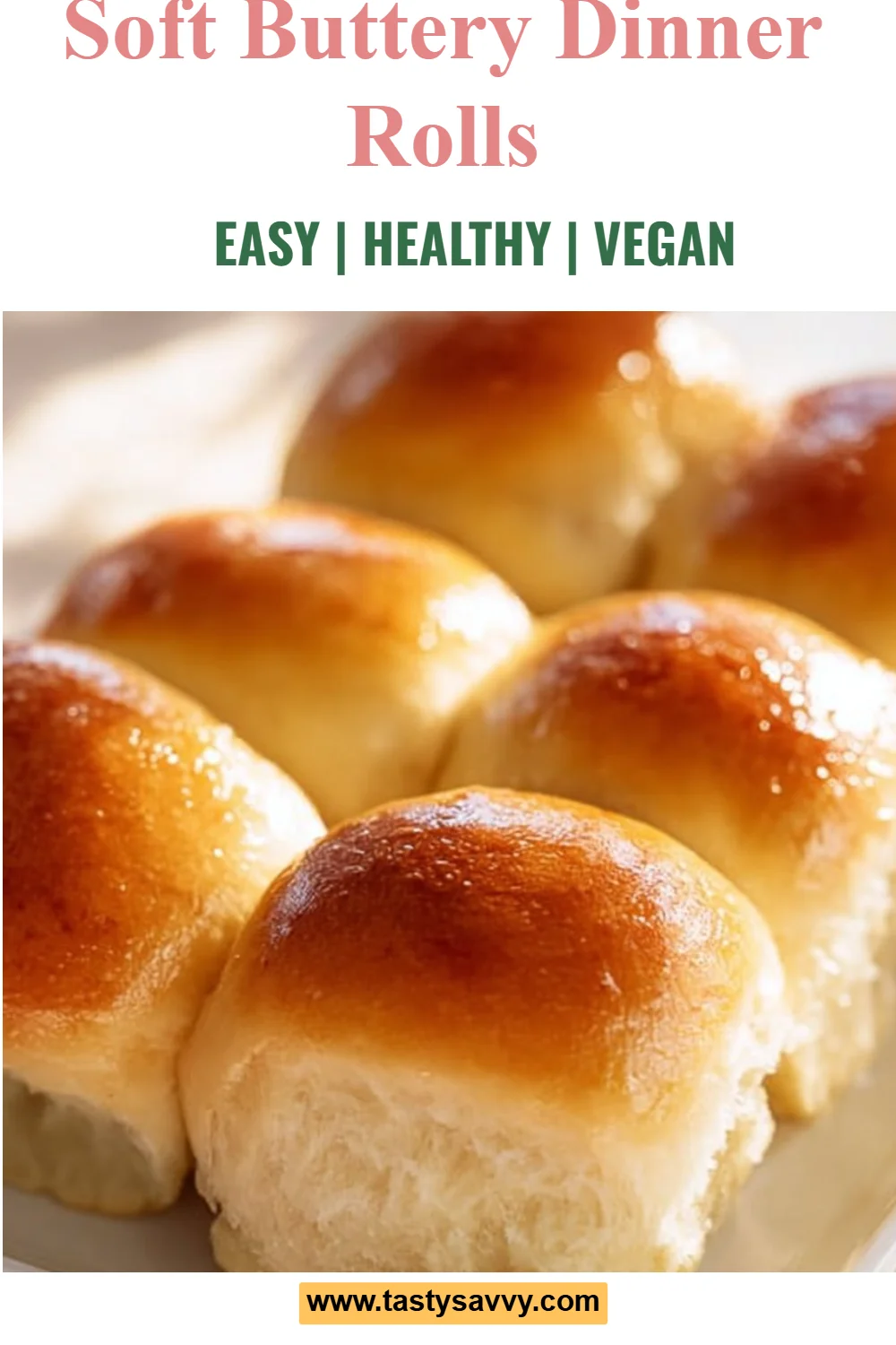 Freshly baked soft buttery dinner rolls on a wooden table