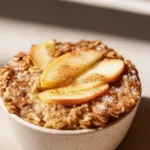 Fluffy baked apple cinnamon oatmeal cups served in a rustic dish