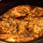 Tender slow cooker chicken breasts ready to serve with herbs and spices