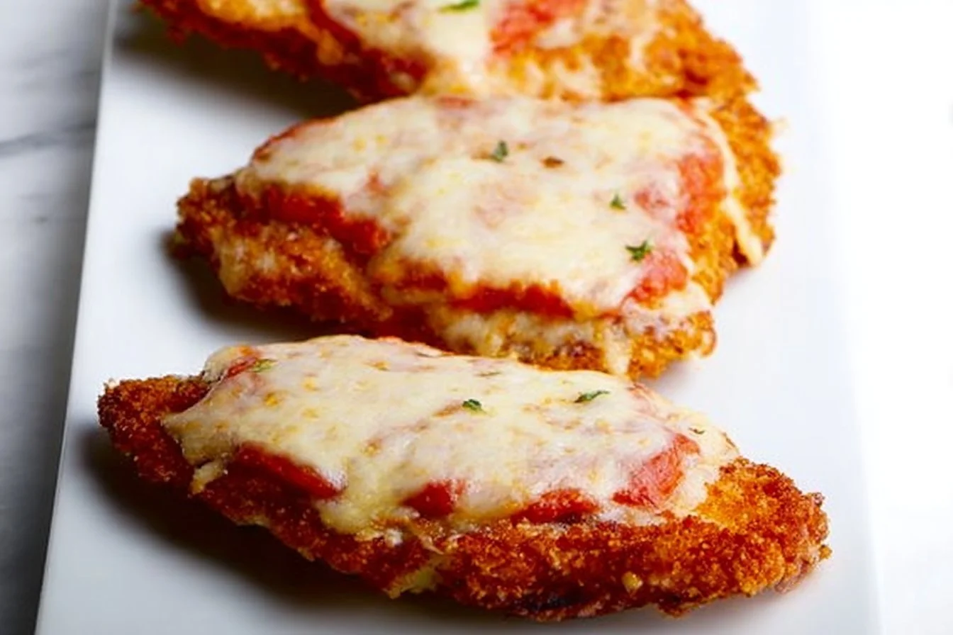 Quick and easy 15-Minute Chicken Parmesan served with pasta and fresh herbs