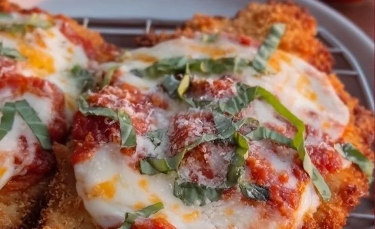 Plate of 30 Minute Chicken Parmesan with melted cheese and marinara sauce