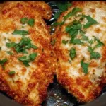 Delicious Air Fryer Chicken Parmesan served with pasta and fresh herbs