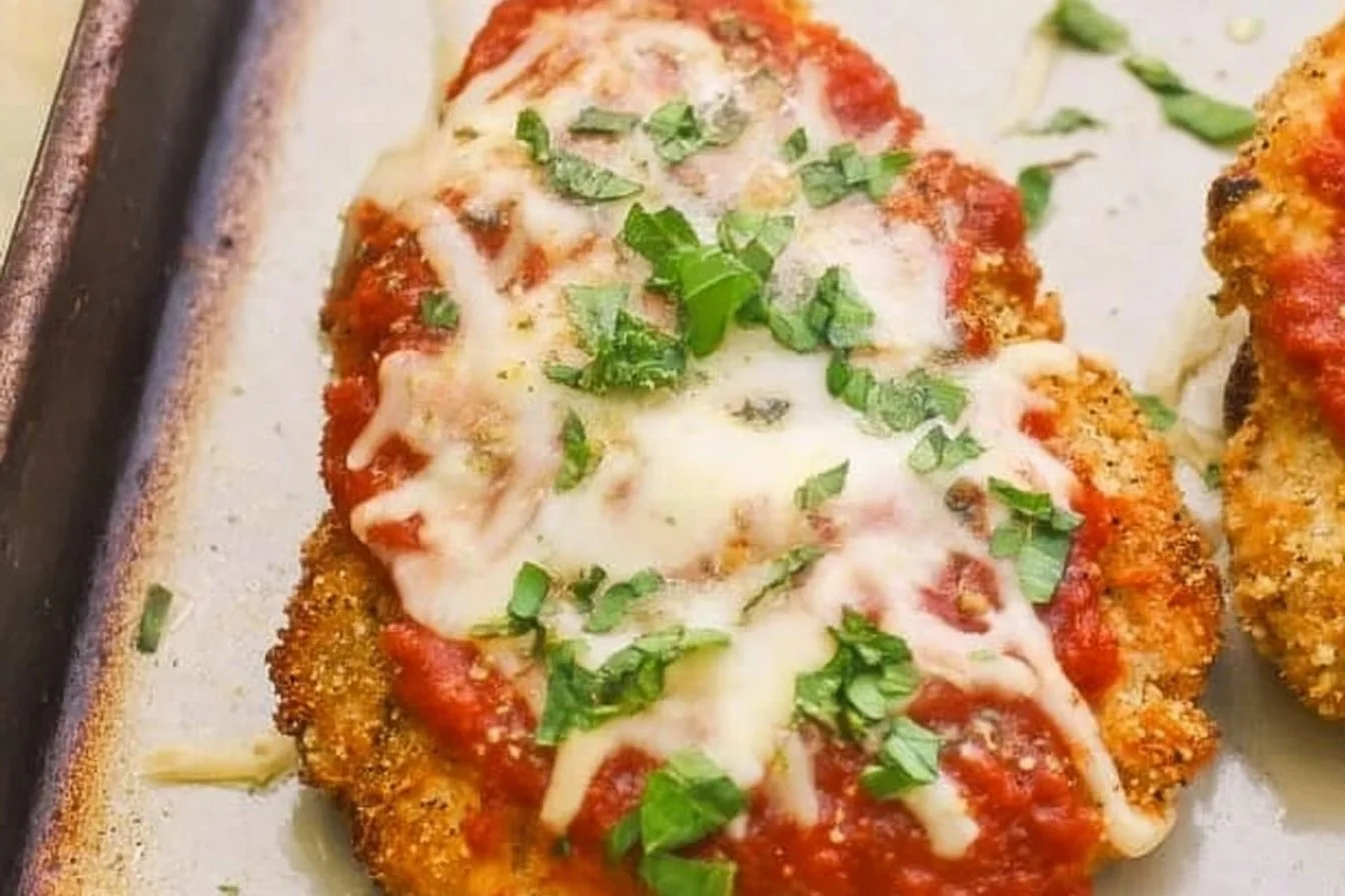 Baked Chicken Parmesan Baked Chicken Parmesan Baked Chicken Parmesan topped with marinara sauce and melted cheese on a plate