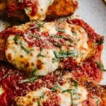 Delicious Chicken Parmesan served with marinara sauce and melted cheese