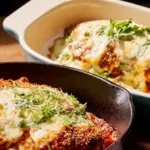 Plate of Chicken Parmesan with marinara sauce and melted cheese