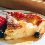 Fluffy German pancakes served with syrup and fresh fruits