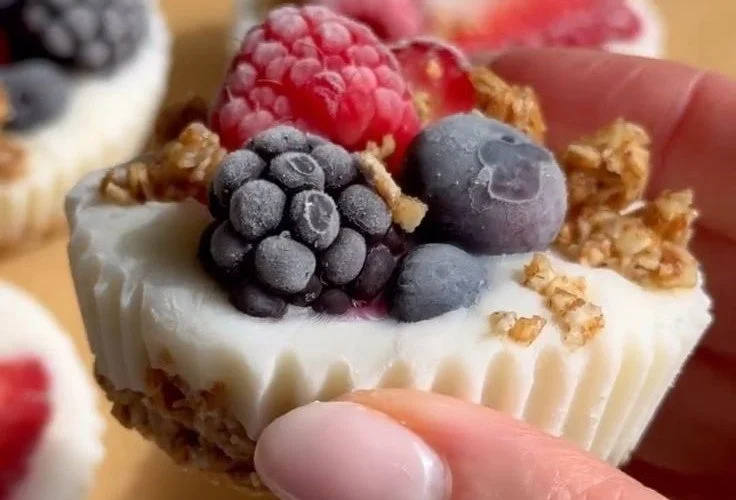 Frozen yogurt cups topped with granola and mixed berries