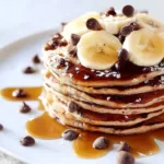 Whole wheat chocolate chip banana bread pancakes stacked on a plate