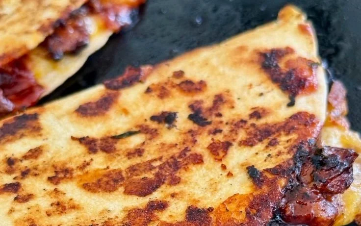 Delicious Blackstone hot honey BBQ chicken quesadillas served on a plate.