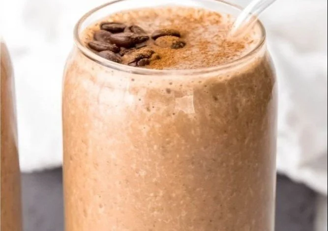 Cold brew coffee protein smoothie in a glass with toppings