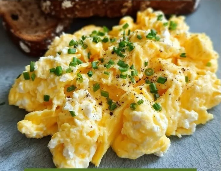 A delicious plate of cottage cheese scrambled eggs topped with herbs