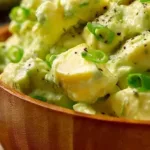 High-protein avocado egg salad served in a bowl with fresh herbs
