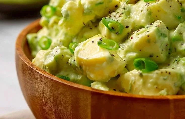 High-protein avocado egg salad served in a bowl with fresh herbs