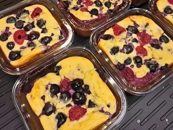 High-protein baked pancake bowls served with fresh berries and syrup