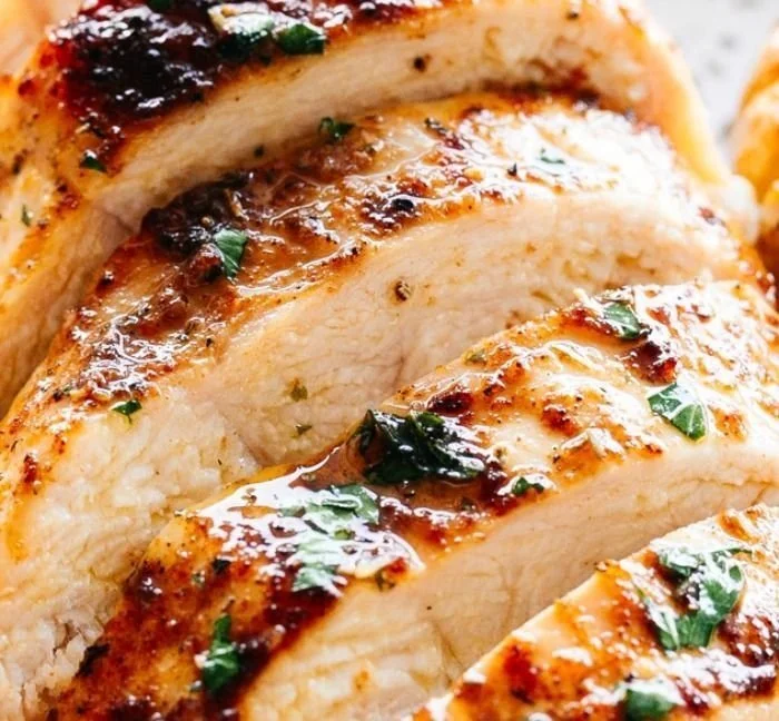Juicy Oven-Baked Chicken Breasts oven-baked chicken Juicy oven-baked chicken breasts served on a plate with herbs and spices.