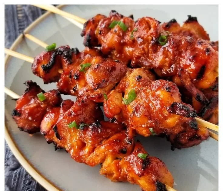 Korean Chicken Skewers Korean Chicken Grilled Korean Chicken Skewers served on a plate with dipping sauce.