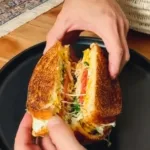 Low-calorie high-protein breakfast sandwich stacked with fresh ingredients