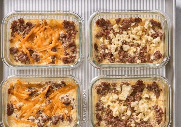 Healthy meal prep breakfast bowls with fresh ingredients and toppings.