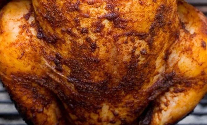 Beer Can Chicken beer can chicken Juicy beer can chicken grilling on a barbecue with spices and herbs.