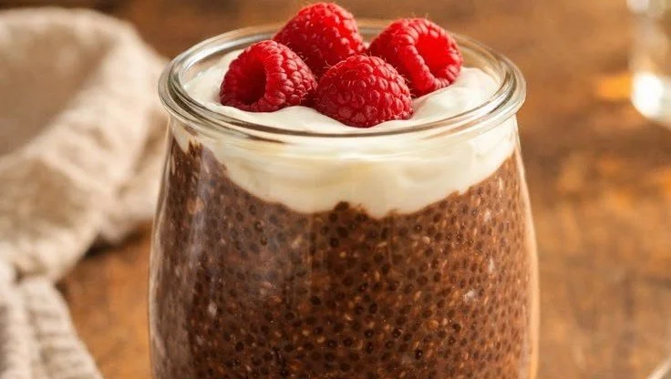 Creamy chocolate chia pudding topped with fresh berries and chocolate shavings.