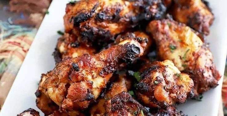 Grilled Jamaican Jerk Chicken Wings jerk chicken Delicious grilled Jamaican jerk chicken wings garnished with fresh herbs